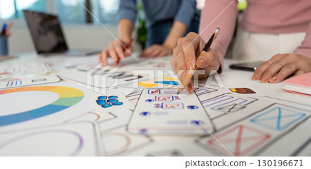 Hands on UX and UI Design. Team members sketching ideas and wireframes on a collaborative project. 130196671