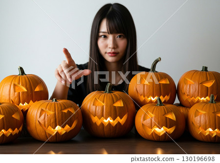 Lots of Halloween pumpkins and a woman 130196698