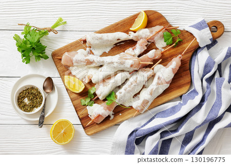 Greek style raw chicken souvlaki on a plate Greek style raw chicken souvlaki on a plate 130196775