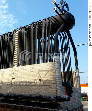 Installation of a Steam Boiler at an Industrial Site Under a Clear Blue Sky Installation of a Steam Boiler at an Industrial Site Under a Clear Blue Sky 130197329