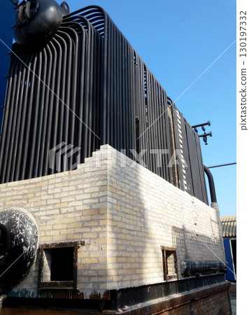 Installation of a Steam Boiler in an Industrial Setting During Daytime 130197332