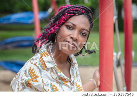 African American female educator working at kindergarten playground daycare teacher professional portrait 130197546