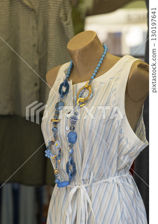 Blue and Gold Necklace Enhancing Striped Dress on Mannequin in Nyons, France 130197641