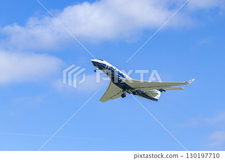 Private jet taking off from Hostivice Airport in Czechia under blue sky 130197710