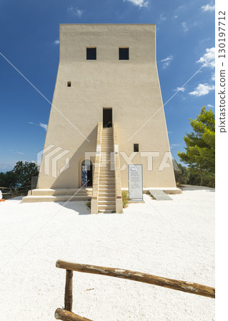 Torre di Porticello standing tall in Vieste, Italy, under blue sky 130197712