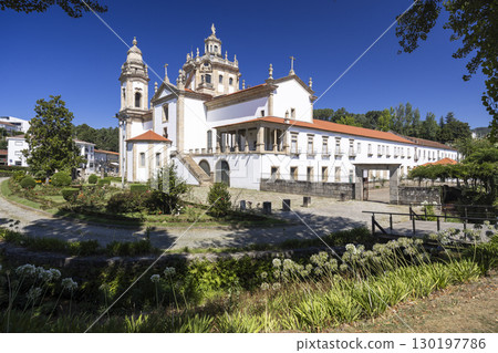 Mosteiro de Sao Miguel de Refojos illuminating Cabeceiras de Basto, Portugal, under summer sky 130197786