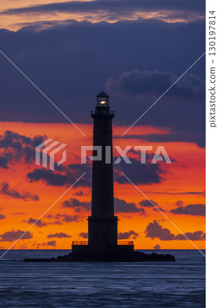 La Hague Lighthouse Silhouette against a Dramatic Sunset in Normandy, France 130197814
