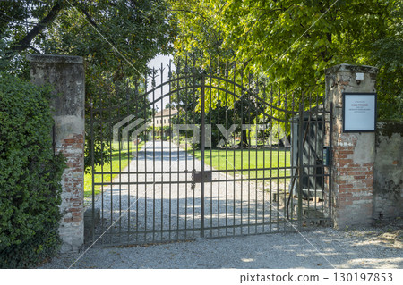 Closed wrought iron gate leading to a country house in Venice, Italy 130197853