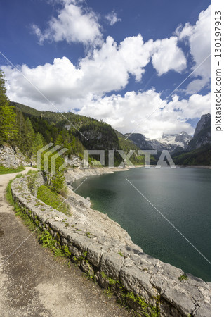 Gosaulack, Upper Austria, road along the lake with Dachstein Mountains in the background Gosaulack, Upper Austria, road along the lake with Dachstein Mountains in the background 130197913