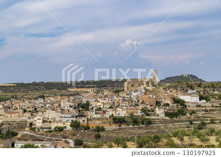 Ciutadilla, Spain, panoramic view of the medieval castle dominating the village under a cloudy sky Ciutadilla, Spain, panoramic view of the medieval castle dominating the village under a cloudy sky 130197925