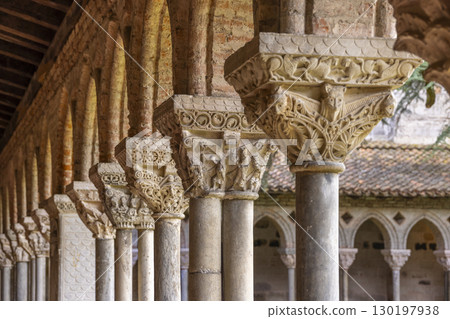 Sculpted columns supporting arches in Moissac Abbey cloister, France 130197938