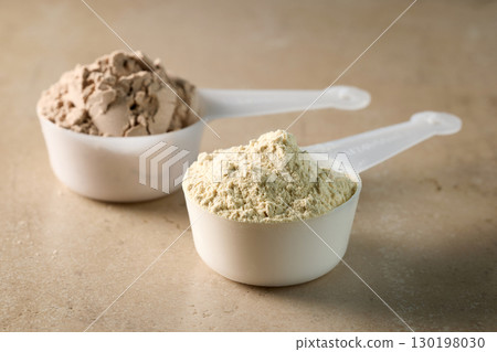 protein powder in scoops. dry mixture for preparation of sporting or dietary drink. 130198030