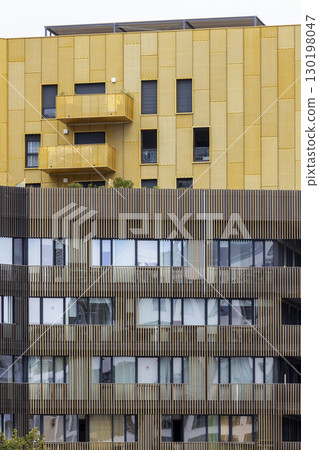 Modern building facade with balconies and wooden cladding in Montpellier, France 130198047