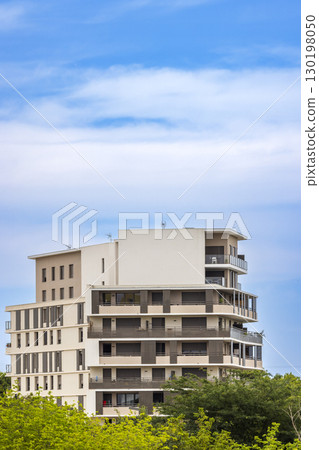 Modern Apartment Building with Balconies in Montpellier, France, under a Blue Sky 130198050
