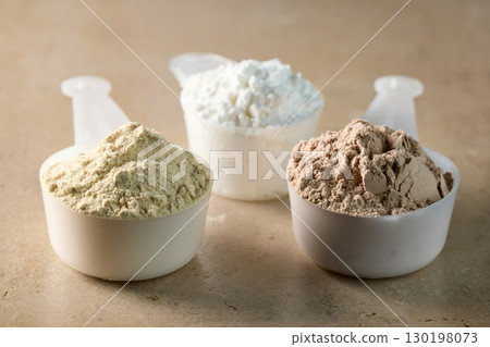 protein powder in scoops. dry mixture for preparation of sporting or dietary drink. 130198073