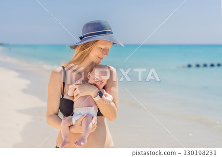 Mother holding her newborn baby by the turquoise sea, sharing a peaceful and loving moment. Family bonding, motherhood, and travel with baby concept Mother holding her newborn baby by the turquoise sea, sharing a peaceful and loving moment. Family bonding, motherhood, and travel with baby concept 130198231