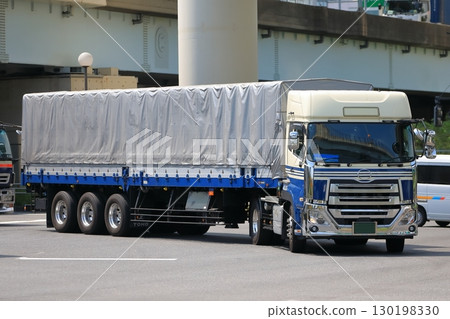 A trailer truck turning right at an intersection A trailer truck turning right at an intersection 130198330