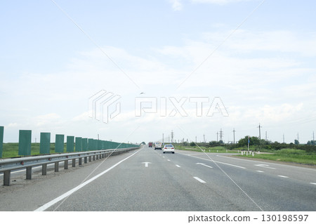 A one-way track, cars are driving along the road. A one-way track, cars are driving along the road. 130198597