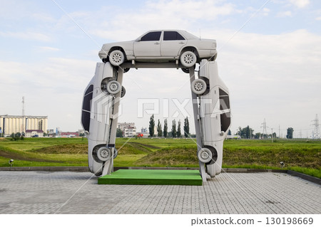 Homemade sculpture of three cars. Monument to the cyrillic lette Homemade sculpture of three cars. Monument to the cyrillic lette 130198669
