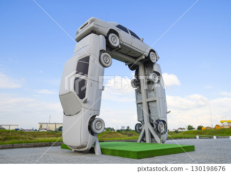 Homemade sculpture of three cars. Monument to the cyrillic lette 130198676