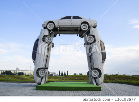 Homemade sculpture of three cars. Monument to the cyrillic lette 130198677