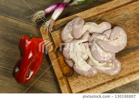 Cow bowels presented on a wooden board with ingredients, ready to grill 130198807