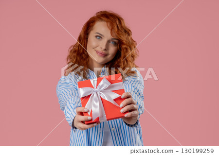Happy Charming Woman Gift Box On PInk Background. Young Girl Smiling,Gives You 130199259
