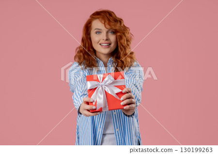 Happy Charming Woman Gift Box On PInk Background. Young Girl Smiling,Gives You Happy Charming Woman Gift Box On PInk Background. Young Girl Smiling,Gives You 130199263