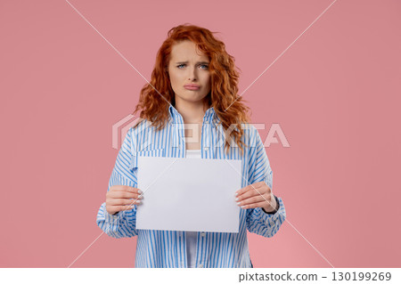 Young Sad Woman Holding Blank Billboard In Hands On Pink. Copy space, Mockup Young Sad Woman Holding Blank Billboard In Hands On Pink. Copy space, Mockup 130199269