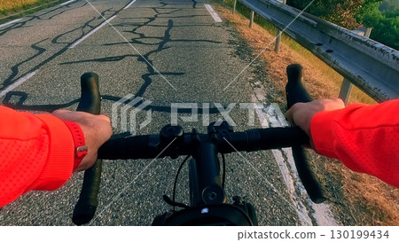 Cycling POV on cracked old mountain road in French Alps 130199434