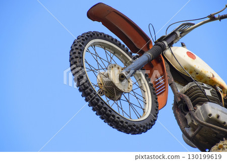 Motorcycle on the pedestal. A light motorbike on a pole, put up 130199619