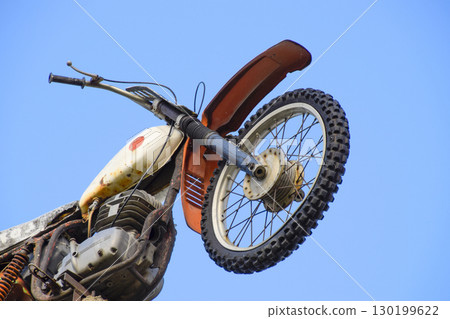 Motorcycle on the pedestal. A light motorbike on a pole, put up Motorcycle on the pedestal. A light motorbike on a pole, put up 130199622