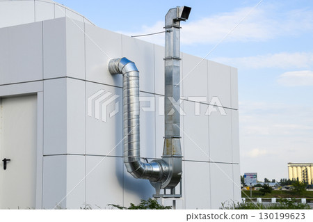 Ventilation hood with a pipe behind the cafe building. Ventilation hood with a pipe behind the cafe building. 130199623