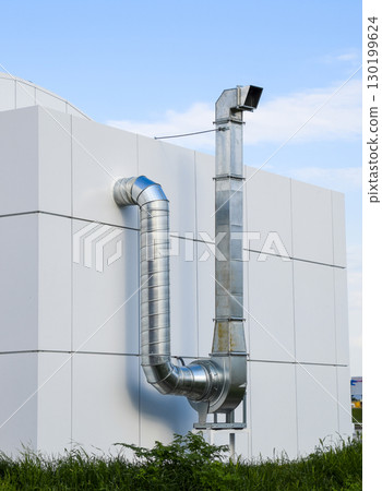 Ventilation hood with a pipe behind the cafe building. 130199624