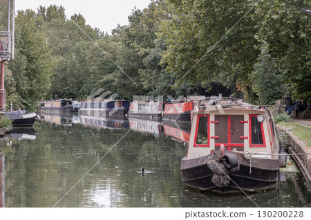 Narrowboats and Houseboats moored on the water alongside the Grand Union Canal. 130200228