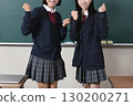 A female student posing in front of a blackboard 130200271
