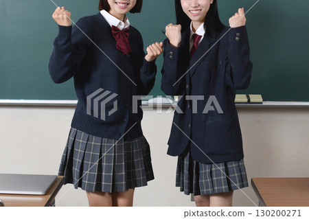 A female student posing in front of a blackboard 130200271