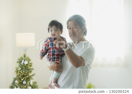 Grandpa holding a grandchild Grandpa holding a grandchild 130200324
