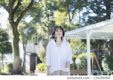 Middle-aged woman walking in the park Middle-aged woman walking in the park 130200400