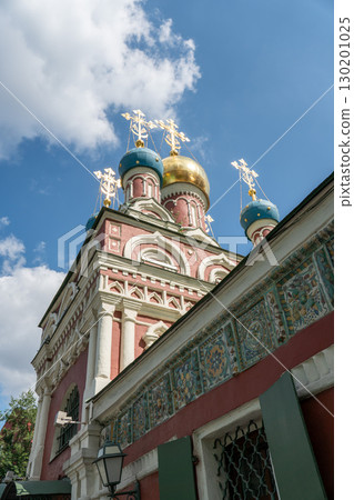 Ornate domes of the Assumption Church (Uspenskaya) in Taganka district, Moscow, with gleaming golden and blue cupolas crowned by Orthodox crosses 130201025