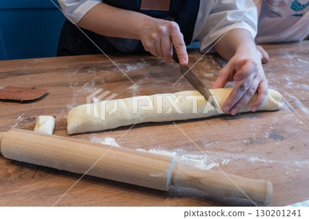 Woman preparing traditional cinnamon rolls in kitchen Woman preparing traditional cinnamon rolls in kitchen 130201241