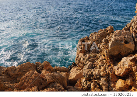 Sea and rocky Mediterranean beach, waves crashing against stones 130203233
