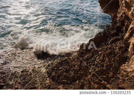 Sea and rocky Mediterranean beach, waves crashing against stones 130203235