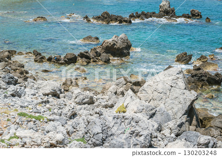 Greek rocky beach with turquoise water and coastal scenery Greek rocky beach with turquoise water and coastal scenery 130203248