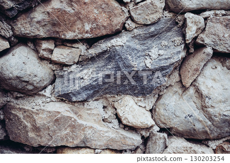 Texture of a massive Greek stone with various shades in Crete 130203254