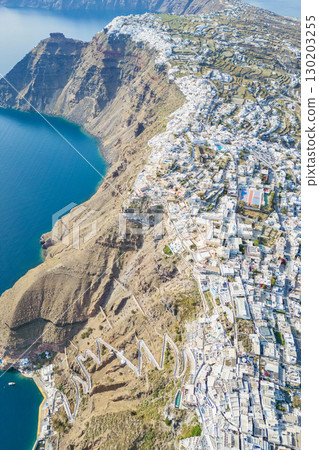 Drone aerial view of Fira town and caldera cliffs with. blue sea, Santorini, Greece Drone aerial view of Fira town and caldera cliffs with. blue sea, Santorini, Greece 130203255