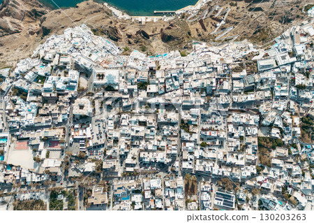 Aerial drone photo of beautiful Fira town on Santorini with white houses and dense layout Aerial drone photo of beautiful Fira town on Santorini with white houses and dense layout 130203263