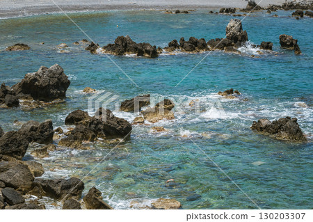Greek beach in Crete island with clear water and massive stones, difficult entry Greek beach in Crete island with clear water and massive stones, difficult entry 130203307
