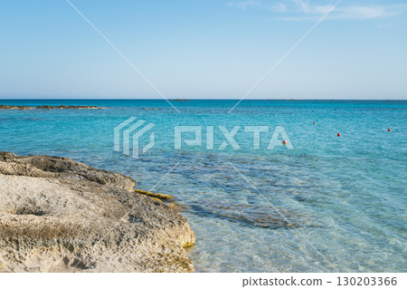 Transparent turquoise sea water and rocky beach, clean seabed and rescue buoys in the water Transparent turquoise sea water and rocky beach, clean seabed and rescue buoys in the water 130203366