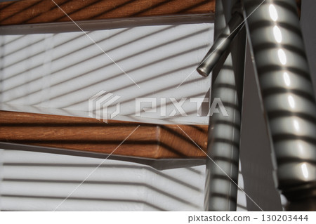 Sun-kissed wooden stairs with shadow play 130203444